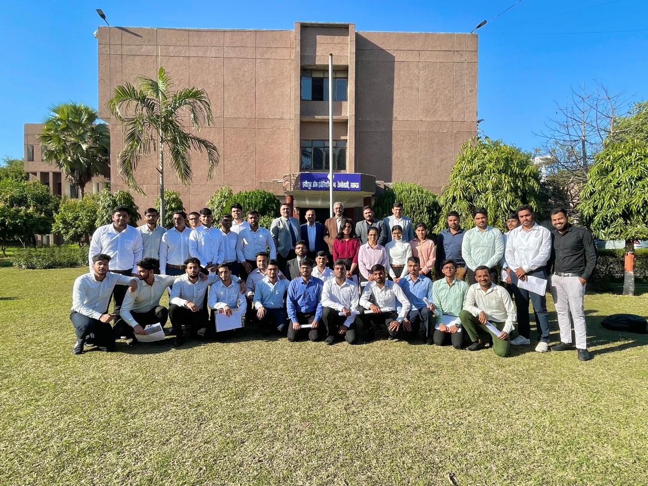 Students and faculty members posing outside the director's office after company placement interviews.